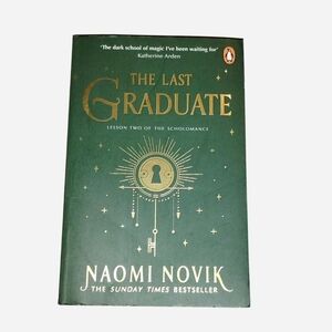 Paperback copy of The Last Graduate, a fantasy novel by Naomi Novik